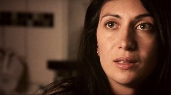 Movie still from “Lake Mungo” (2008), directed by Joel Anderson – A woman's face in a dark room; Close Up shot, High angle