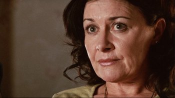 Movie still from “Lake Mungo” (2008), directed by Joel Anderson – A woman's face with green eyes; Close Up shot, Low angle