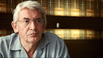 Movie still from “Lake Mungo” (2008), directed by Joel Anderson – An older man wearing glasses sitting in front of a book shelf; Close Up shot, Low angle