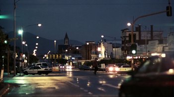 Movie still from “Lake Mungo” (2008), directed by Joel Anderson – A city street at night lit by street lights; Extreme Wide shot, Low angle