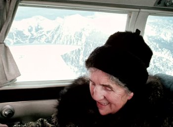 Movie still from “Land of Silence and Darkness” (1971), directed by Werner Herzog – An older woman wearing a black hat and a fur coat; Close Up shot, High angle