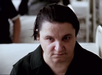 Movie still from “Land of Silence and Darkness” (1971), directed by Werner Herzog – A person wearing a black shirt; Close Up shot, High angle