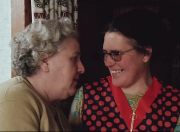 Movie still from “Land of Silence and Darkness” (1971), directed by Werner Herzog – Two women sitting next to each other in a room; Close Up shot, Over the shoulder angle
