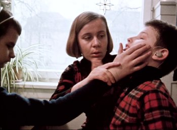 Movie still from “Land of Silence and Darkness” (1971), directed by Werner Herzog – A man and a woman in a room; Medium shot, Over the shoulder angle
