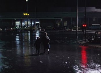 Movie still from “Landscape in the Mist” (1988), directed by Theodoros Angelopoulos – A woman and a little girl walking down the street at night; Extreme Wide shot, High angle