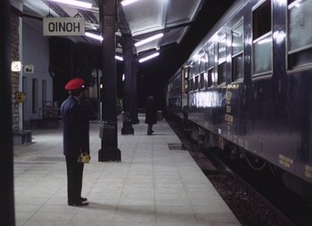 Movie still from “Landscape in the Mist” (1988), directed by Theodoros Angelopoulos – A man standing in front of a train; Wide shot, Low angle