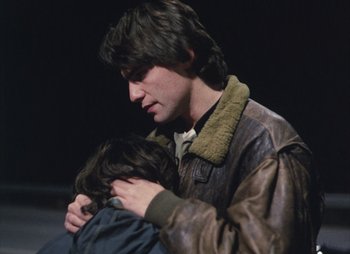 Movie still from “Landscape in the Mist” (1988), directed by Theodoros Angelopoulos – A young man holding a young woman in his arms; Close Up shot, Over the shoulder angle
