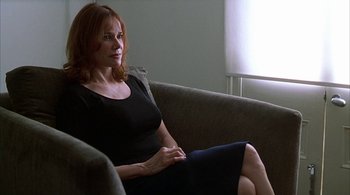 Movie still from “Lantana” (2001), directed by Ray Lawrence – A woman sitting on top of a couch in a living room; Medium shot, Low angle