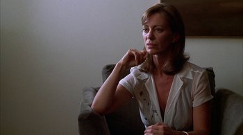 Movie still from “Lantana” (2001), directed by Ray Lawrence – A woman sitting in a chair with her hand under her chin; Close Up shot, Low angle