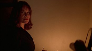 Movie still from “Lantana” (2001), directed by Ray Lawrence – A woman standing in front of a lit candle in a room; Close Up shot, Low angle