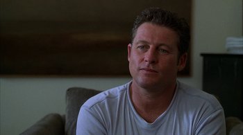 Movie still from “Lantana” (2001), directed by Ray Lawrence – A person sitting on a couch; Close Up shot, Over the shoulder angle