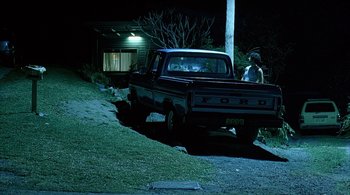 Movie still from “Lantana” (2001), directed by Ray Lawrence – A truck parked on the side of the road at night; Wide shot, High angle