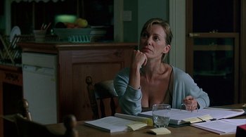 Movie still from “Lantana” (2001), directed by Ray Lawrence – A woman sitting at a dining room table; Medium shot, Over the shoulder angle