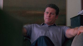 Movie still from “Lantana” (2001), directed by Ray Lawrence – A person sitting on a couch; Medium shot, Over the shoulder angle