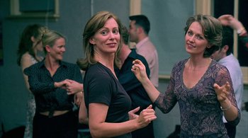 Movie still from “Lantana” (2001), directed by Ray Lawrence – Two women are dancing together in a room; Medium shot, Over the shoulder angle