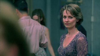 Movie still from “Lantana” (2001), directed by Ray Lawrence – A woman standing in front of two other people; Close Up shot, Over the shoulder angle