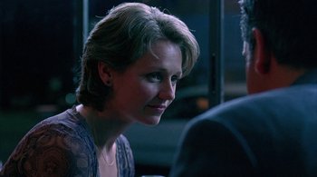 Movie still from “Lantana” (2001), directed by Ray Lawrence – A person sitting at a table; Close Up shot, Over the shoulder angle