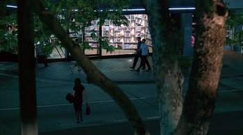 Movie still from “Lantana” (2001), directed by Ray Lawrence – Two people are walking down the street at night; Extreme Wide shot, High angle
