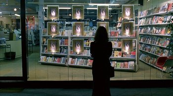 Movie still from “Lantana” (2001), directed by Ray Lawrence – A woman standing in front of a book store window; Wide shot, High angle