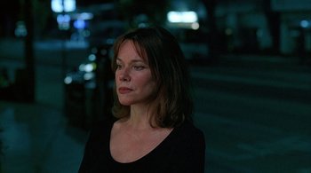 Movie still from “Lantana” (2001), directed by Ray Lawrence – A woman in a black shirt is standing in the dark; Close Up shot, Over the shoulder angle