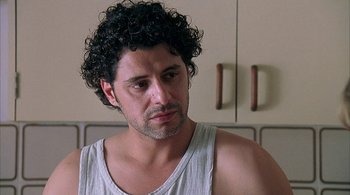 Movie still from “Lantana” (2001), directed by Ray Lawrence – A person wearing a tank top; Close Up shot, Over the shoulder angle