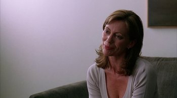 Movie still from “Lantana” (2001), directed by Ray Lawrence – A woman sitting on a couch looking at the camera; Close Up shot, Over the shoulder angle