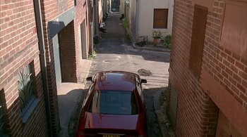 Movie still from “Lantana” (2001), directed by Ray Lawrence – A car parked in the middle of an alleyway; Extreme Wide shot, High angle