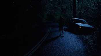Movie still from “Lantana” (2001), directed by Ray Lawrence – A person walking down a street at night; Wide shot, High angle