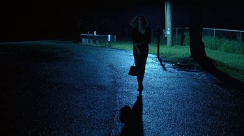 Movie still from “Lantana” (2001), directed by Ray Lawrence – A woman running down a street at night; Wide shot, Low angle