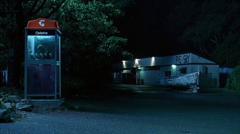 Movie still from “Lantana” (2001), directed by Ray Lawrence – A bus stop at night in the middle of the night; Extreme Wide shot, High angle