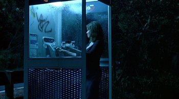 Movie still from “Lantana” (2001), directed by Ray Lawrence – A woman standing in front of a store window at night; Medium shot, Low angle