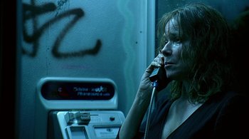 Movie still from “Lantana” (2001), directed by Ray Lawrence – A woman talking on a phone while standing next to an atm machine; Close Up shot, High angle