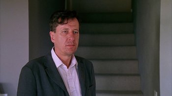 Movie still from “Lantana” (2001), directed by Ray Lawrence – A person wearing a suit and tie; Close Up shot, Low angle