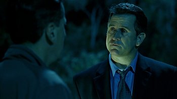 Movie still from “Lantana” (2001), directed by Ray Lawrence – A man wearing a suit and tie talking to another man wearing a suit and tie; Close Up shot, Over the shoulder angle