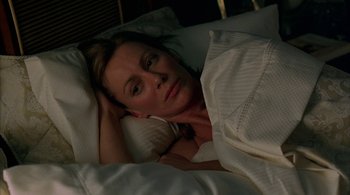 Movie still from “Lantana” (2001), directed by Ray Lawrence – A woman laying in a bed under a white blanket; Close Up shot, High angle