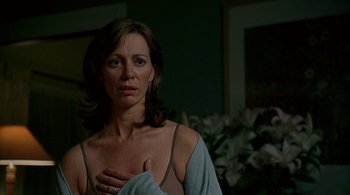 Movie still from “Lantana” (2001), directed by Ray Lawrence – A woman standing in front of a mirror with her hands on her chest; Close Up shot, Low angle