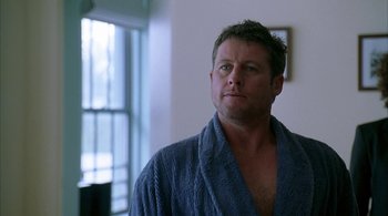 Movie still from “Lantana” (2001), directed by Ray Lawrence – A man wearing a robe in a room with a window in the background; Close Up shot, Over the shoulder angle