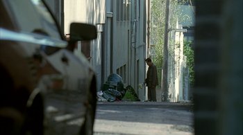 Movie still from “Lantana” (2001), directed by Ray Lawrence – A man walking down a street with a car in the background; Extreme Wide shot, High angle