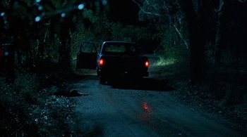 Movie still from “Lantana” (2001), directed by Ray Lawrence – A car that is parked on the side of the road; Wide shot, High angle