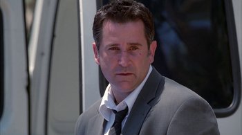 Movie still from “Lantana” (2001), directed by Ray Lawrence – A person wearing a suit and tie; Close Up shot, Low angle