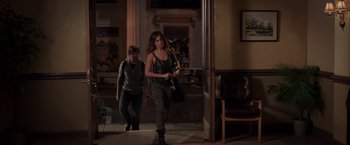 Movie still from “We're the Millers” (2013), directed by Rawson Marshall Thurber – A woman walking down the street while holding a camera; Wide shot, Over the shoulder angle