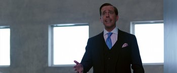Movie still from “We're the Millers” (2013), directed by Rawson Marshall Thurber – A man wearing a suit and tie talking to someone; Medium shot, Over the shoulder angle