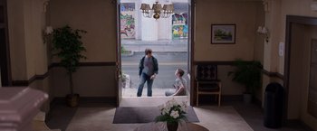 Movie still from “We're the Millers” (2013), directed by Rawson Marshall Thurber – Two people standing in front of an open door; Wide shot, Over the shoulder angle