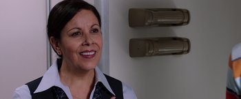 Movie still from “We're the Millers” (2013), directed by Rawson Marshall Thurber – A woman wearing a black tie and a white shirt smiling; Close Up shot, Over the shoulder angle