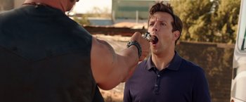 Movie still from “We're the Millers” (2013), directed by Rawson Marshall Thurber – A man is being fitted with a tooth brush; Medium shot, Over the shoulder angle