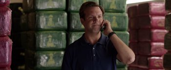 Movie still from “We're the Millers” (2013), directed by Rawson Marshall Thurber – A man talking on a cell phone in front of a wall of chess pieces; Close Up shot, Low angle