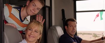 Movie still from “We're the Millers” (2013), directed by Rawson Marshall Thurber – A man and a woman sitting next to each other on a bus; Medium shot, Over the shoulder angle