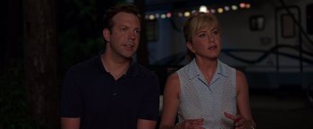 Movie still from “We're the Millers” (2013), directed by Rawson Marshall Thurber – A man and a woman sitting next to each other in front of lights; Close Up shot, Over the shoulder angle