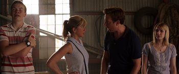 Movie still from “We're the Millers” (2013), directed by Rawson Marshall Thurber – A man and a woman standing next to each other in front of a window; Medium shot, Over the shoulder angle