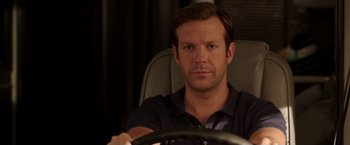 Movie still from “We're the Millers” (2013), directed by Rawson Marshall Thurber – A person sitting in a car holding a steering wheel; Close Up shot, Over the shoulder angle